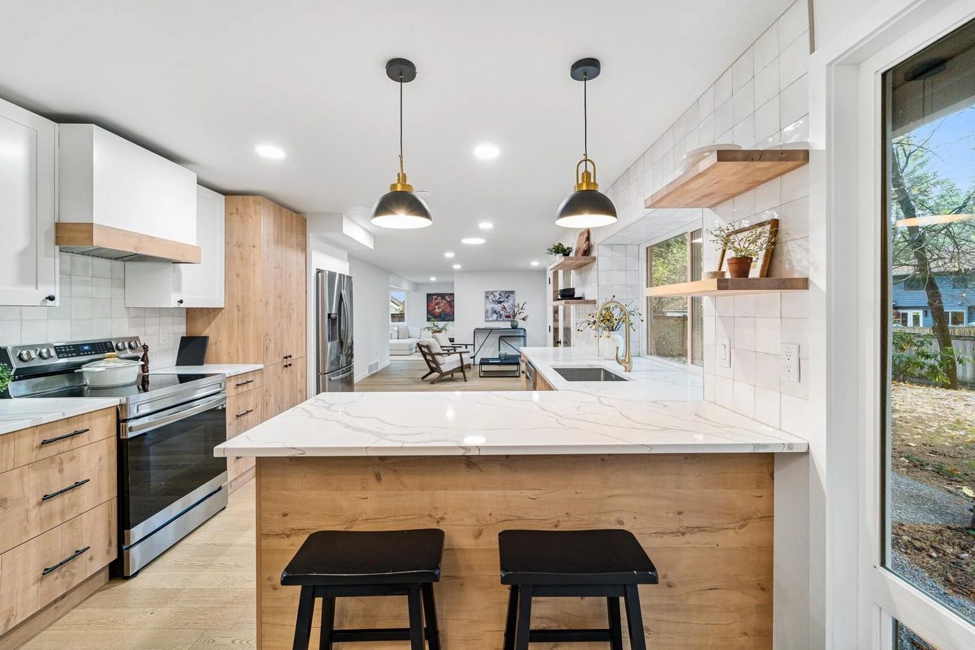 Kitchen with a wood island and black pendants