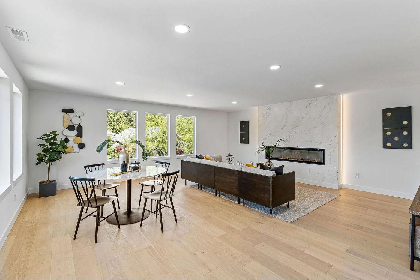 Open living and dining room with a wall of windows