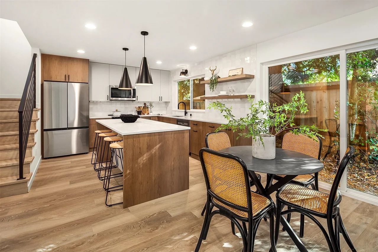 Kitchen and dining area with a round table by the window