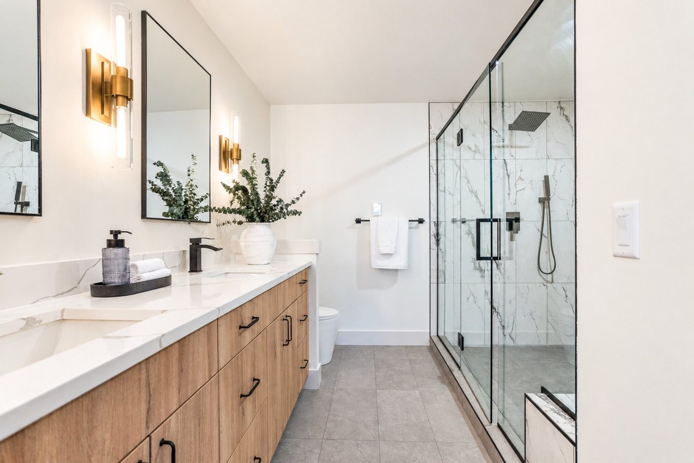Bathroom with a walnut vanity and a glass shower