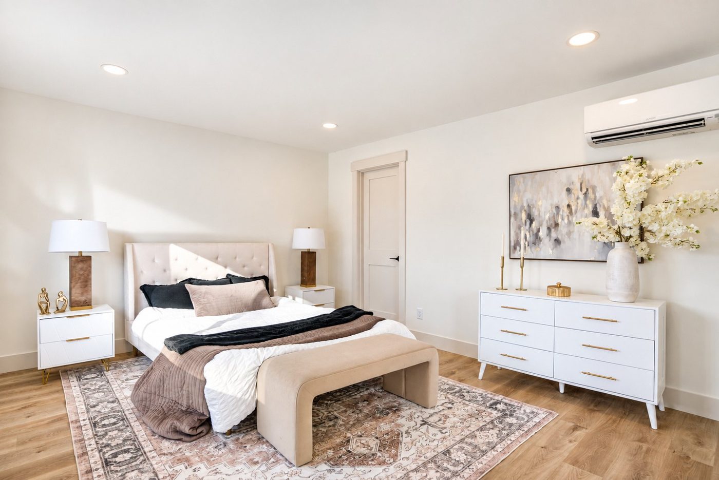 Bedroom with a bench and a white dresser