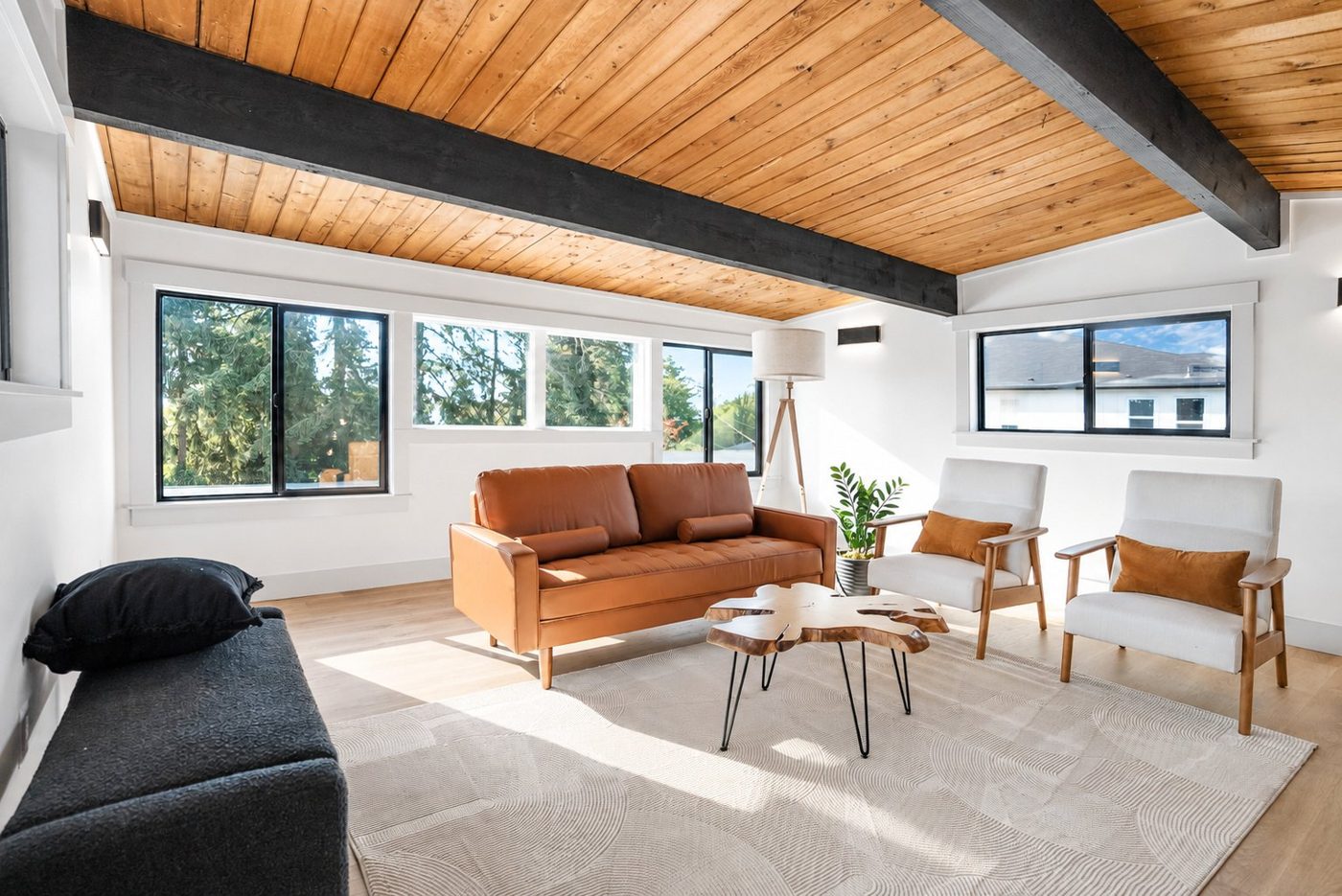 Living room under a wood ceiling with black beams