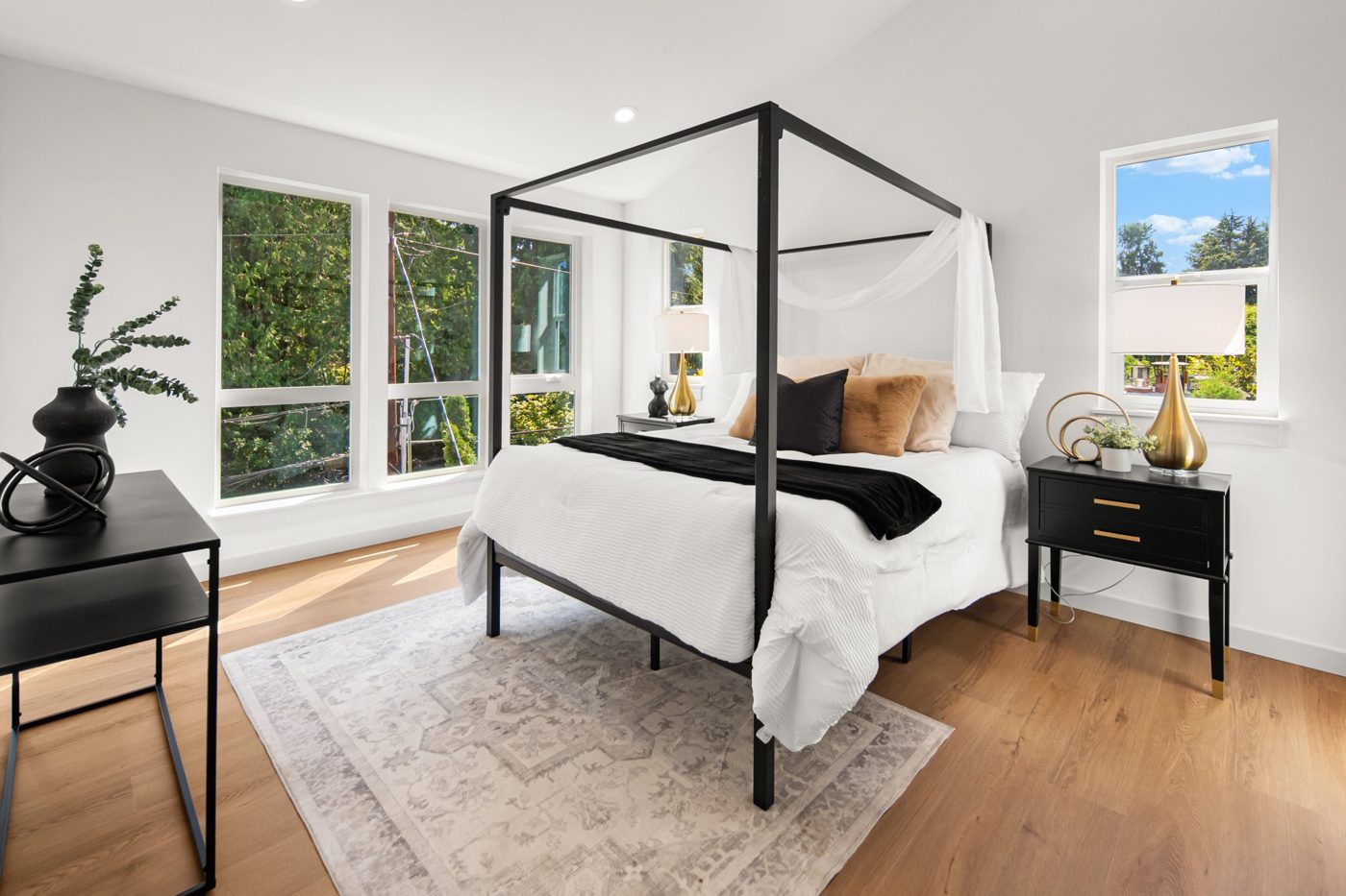 Bedroom with a canopy bed and two windows
