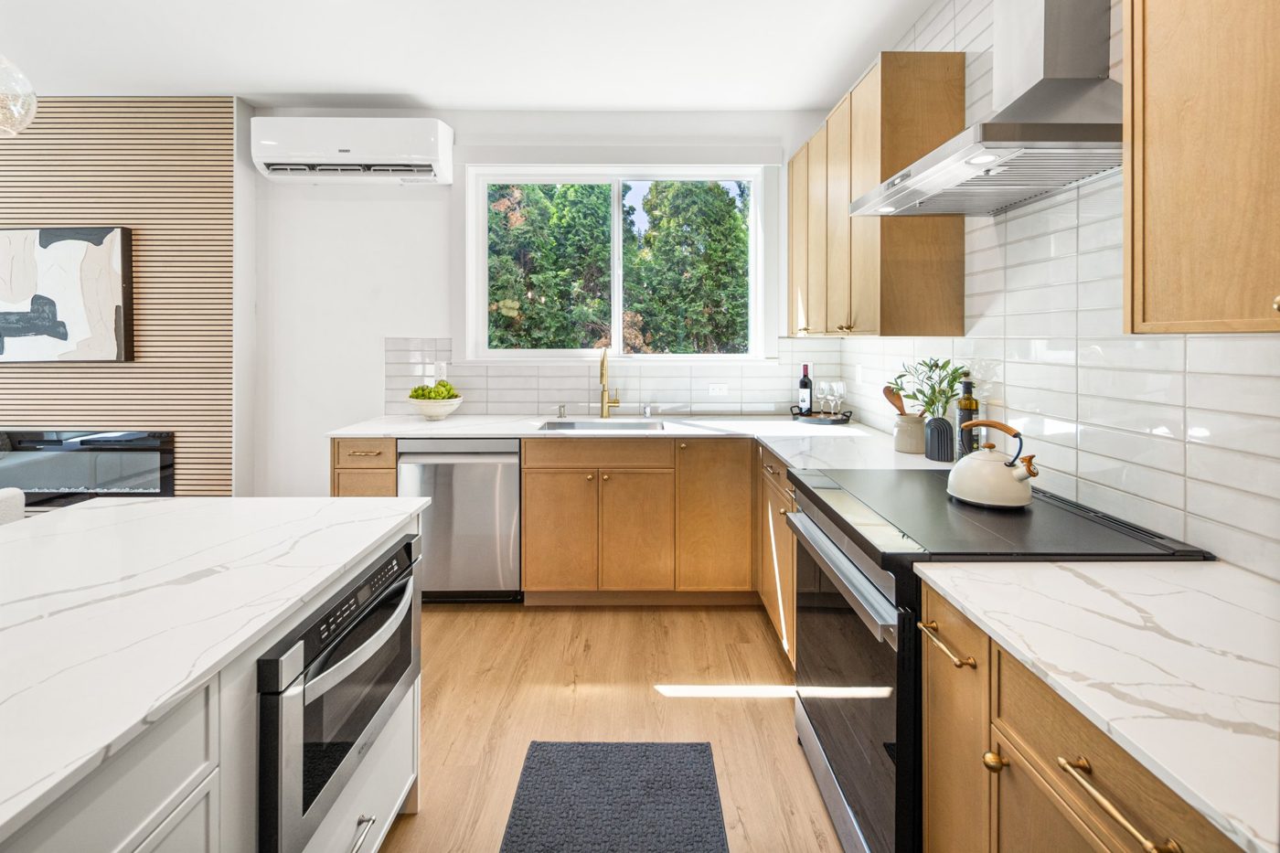 Kitchen run with a wall oven and white tile backsplash
