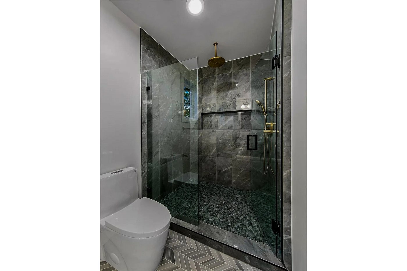 Glass shower with dark tile