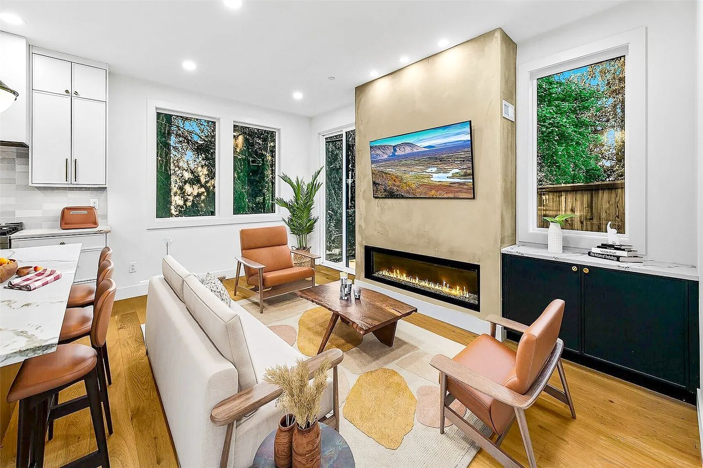 Living room with a linear fireplace and a wall-mounted TV