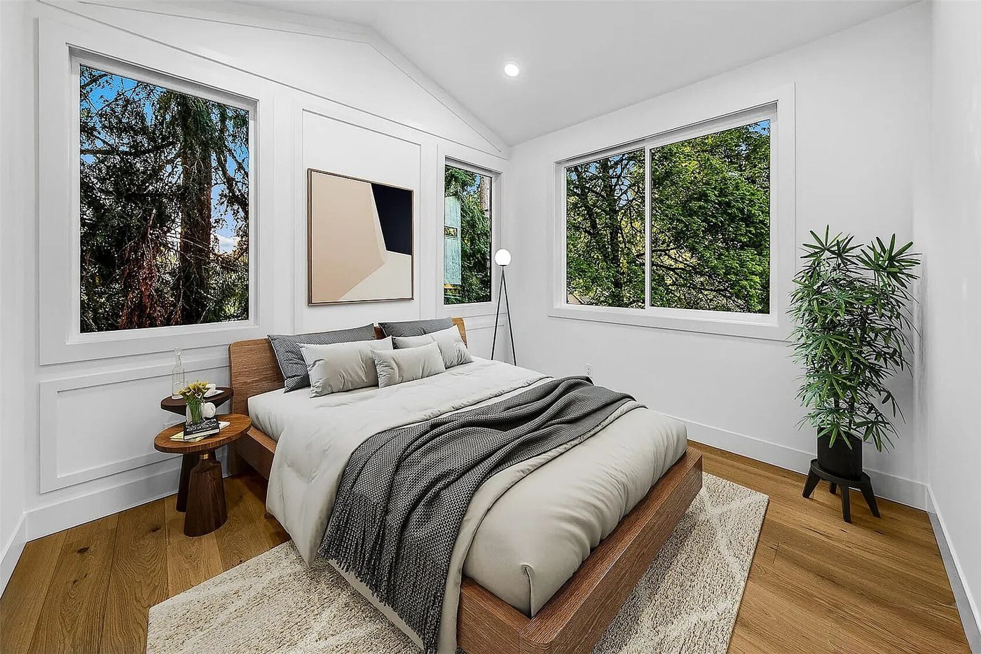 Bedroom with two windows and a grey bed