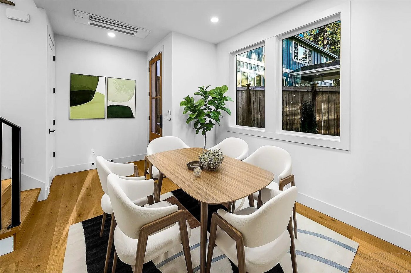 Dining table by the window with a mini-split above