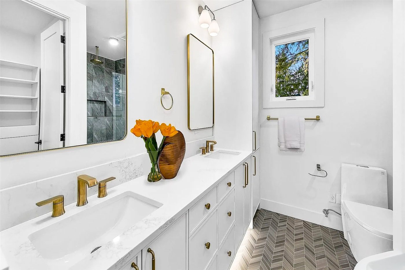 Bathroom with a double vanity and brass fixtures