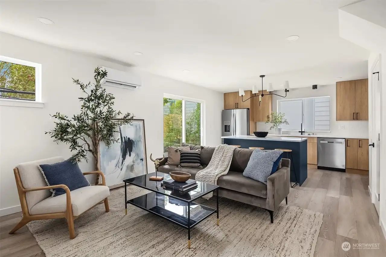 Open living and kitchen area with oak floors