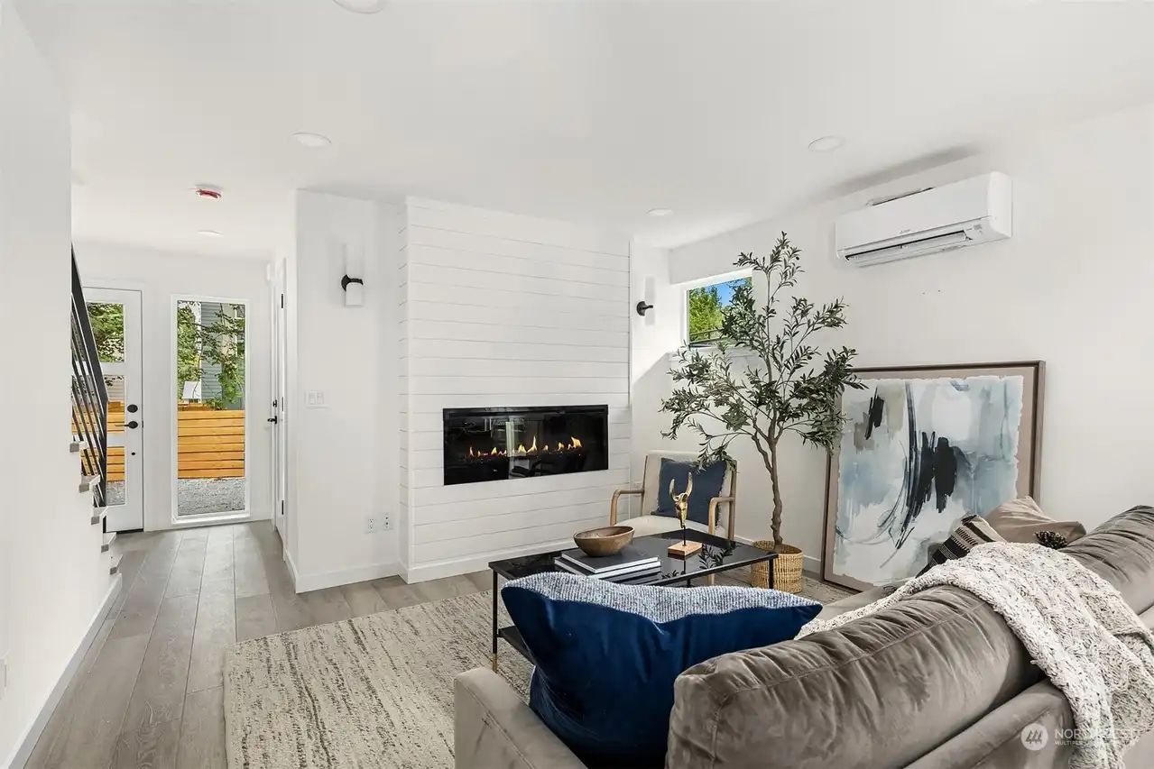 Living room with a linear fireplace and a navy sofa