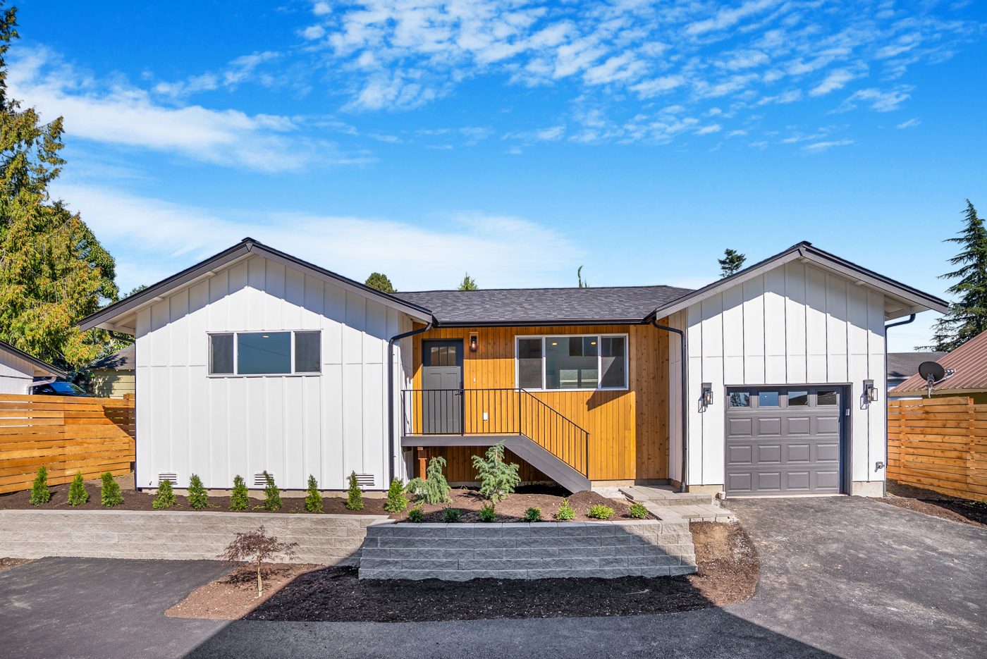 The backyard home from the driveway, with landscaping